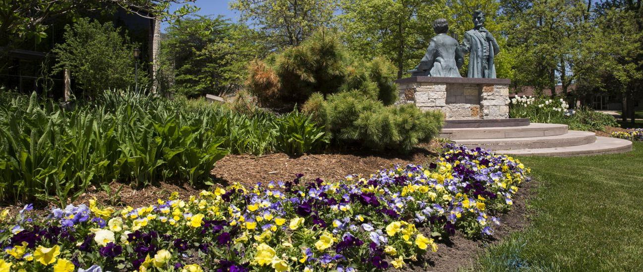 The Lincoln-Hayes statue with flowers in the spring.